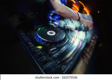 Dj playing disco house progressive electro music at the concert.
 DJ hands on equipment