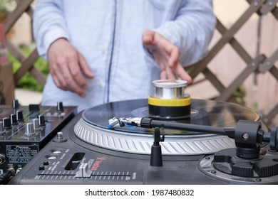 DJ Playing Mixing Music On Vinyl Turntable At Party. Hand Of A Male DJ In A Blue Shirt. Unrecognizable Young White DJ At The Music Desk During A DJ Set On The Terrace Of Bar. Moscow, Russia - 06.05.21