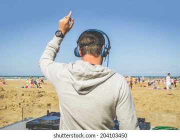 Dj Playing Music At A Beach Party