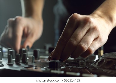 DJ playing music at mixer closeup