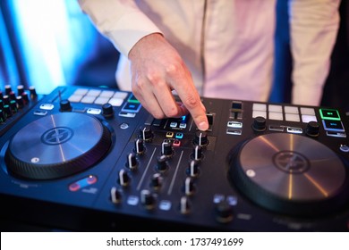 Dj plays beats on drum machine.Hip hop disc jockey playing on concert stage with professional midi controller device. Beat machine device for electronic music composer.