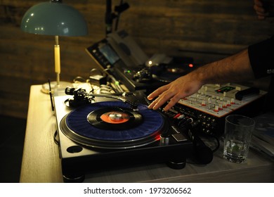 DJ Plays Live Set And Mixing Music On Turntable In The Night Club. Station At Club Party. DJ Mixer Controller Panel For Playing Music And Partying.