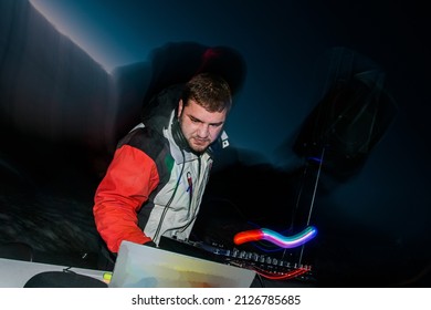 DJ Plays Live Set And Mixing Music On Turntable Console At Stage In The Night Club. Disc Jokey Hands On A Sound Mixer Station At Club Party. DJ Mixer Controller Panel For Playing Music And Partying.