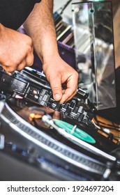 DJ plays old records on the mixing desk