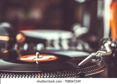 Dj Plays Vinyl Records Player With Music Disc.Turntables At Hip Hop Party In Night Club.Professional Hi-fi Turn Table Equipment For Disc Jockey Playing Musical Tracks On Concert Stage.Vintage Djs Gear