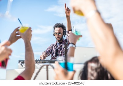 Dj Set At The Beach Party. Dj Spins The Music And People Is Excited With Hands Up. Concept About Party, Music And People