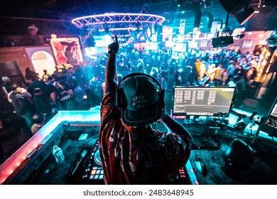 A DJ shouting to the crowd at a bar