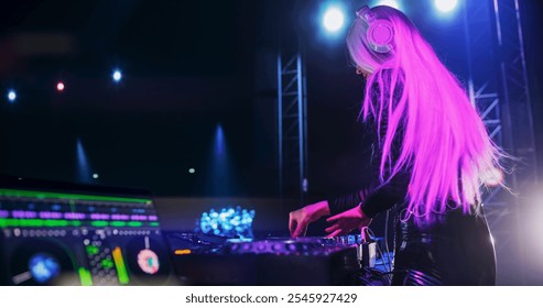 DJ Software with Advanced DJ Workflow with AI and Automation Technology on a Laptop Computer Screen. DJ Using Music Service Application on a Nightclub Stage During a Concert