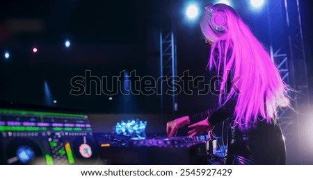 DJ Software with Advanced DJ Workflow with AI and Automation Technology on a Laptop Computer Screen. DJ Using Music Service Application on a Nightclub Stage During a Concert