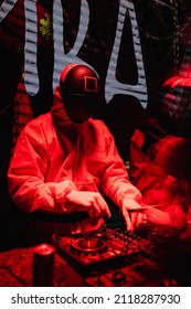 DJ In A Squid Games-themed Costume Plays At The Party. Red Lighting. Party Concept, Night Club. Russia, Rostov-on-Don 5feb2022