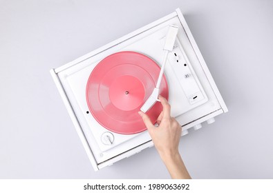 DJ Turntable, Hand Placing Tonearm On White Vinyl Record. Music Concept. Top View