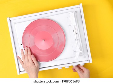 DJ Turntable, Hand Placing Tonearm On White Vinyl Record. Music Concept. Top View