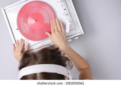 DJ Turntable, Hand Placing Tonearm On White Vinyl Record. Music Concept. Top View