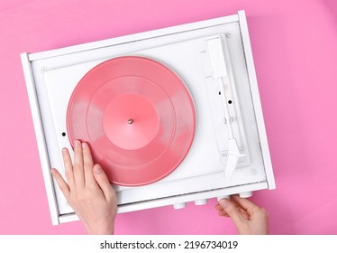 DJ Turntable, Hand Placing Tonearm On Pink Vinyl Record. Music Concept. Top View