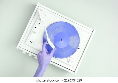 DJ Turntable, Hand Placing Tonearm On White Vinyl Record. Music Concept. Top View