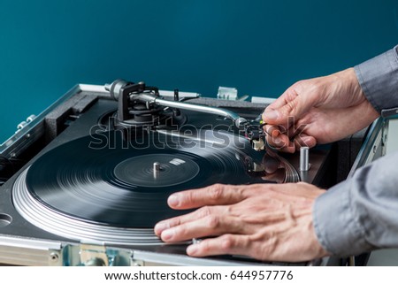 DJ Turntable and Vinyl, Hands Placing Needle on Record 