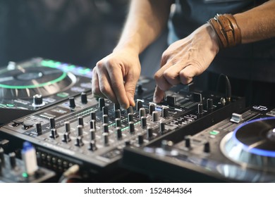 DJ Using Sound Controller To Mix Music. Selective Focus.