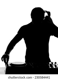 DJ at work. Happy young man is spinning on turntable while isolated on white.