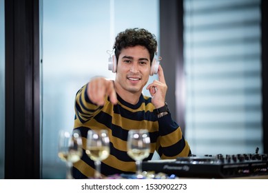 DJ working with Digital Mixer & Controller in celebration party