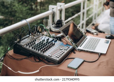 dj working on a computer keyboard. night light, dj console, disco equipment
