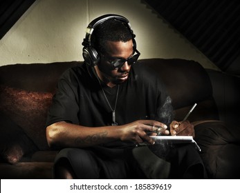 Dj Writing Lyrics On Note Book In Studio