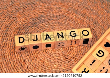 DJANGO word text from wooden cube block letters on braided rattan mats background. Django is a high-level Python web framework that enables rapid development of secure and maintainable websites.