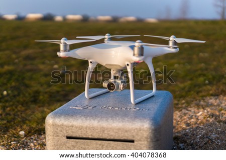 DJI Phantom 4 drone ready for take off standing on a case during sunset