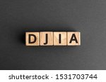 DJIA - acronym from wooden blocks with letters, Dow Jones Industrial Average american stock index DJIA concept,  top view on grey background