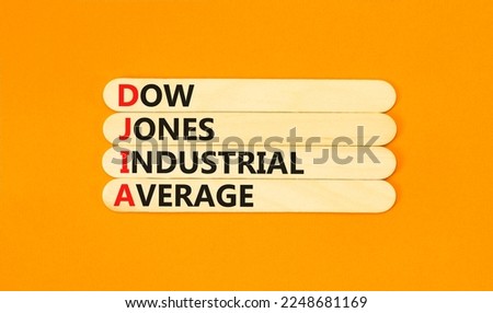 DJIA Dow Jones industrial average symbol. Concept words DJIA Dow Jones industrial average on wooden stick on beautiful orange background. Business DJIA Dow Jones industrial average concept. Copy space