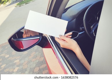 DL Flyer In Hand Sticking Out Of A Car Window Mockup.