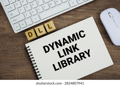 DLL Dynamic Link Library message with keyboard and optical mouse on wooden background
