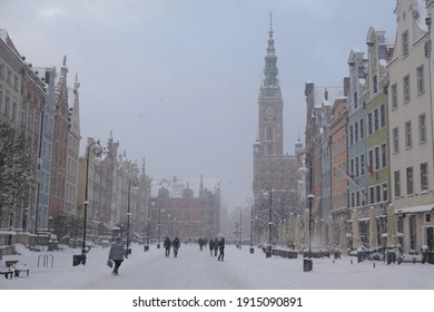 Dlugi Targ street in Gdansk Old Town in a snowy blizzard. Silhouettes of people on the street. Poland - Shutterstock ID 1915090891