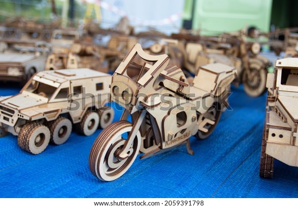Dlugoleka, Poland - September 12, 2021: Wooden\
models of vehicles on display at a picnic in the park. Plywood\
two-wheeled motorcycle\
model