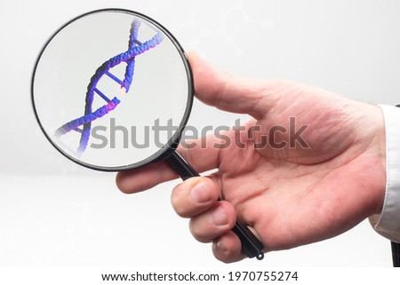 DNA disease concept. A break in genome molecule like sivol DNA disease. Genome molecule under a magnifying glass. Hand with a magnifying glass on a white background. DNA disease in genetics