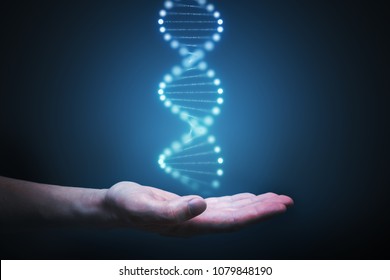 DNA and genetics research concept. Hand is holding glowing DNA molecule in hand.
