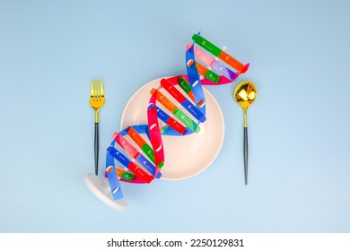DNA helix structure, spoon, fork beside. Personalized food DNA and nutrition, checking allergic food, food intolerance, nutrition effect human life, DNA food and genetically modified foods - Shutterstock ID 2250129831