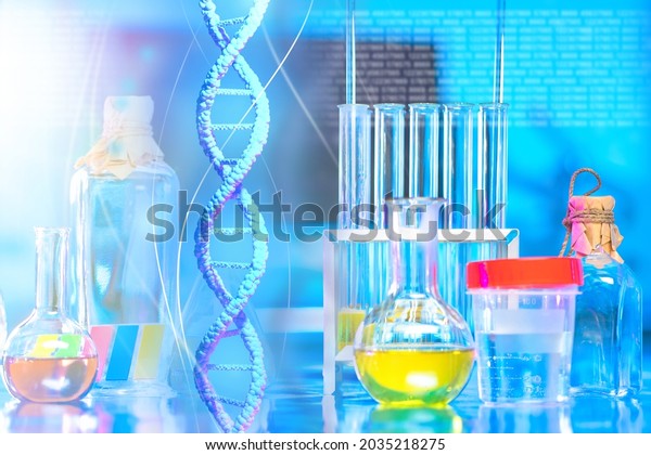 DNA spiral on background of laboratory. DNA\
spiral near medical flasks. Test tubes in genetic laboratory. DNA\
research concept. Experiments in field of genetic engineering.\
Genetic mutation research