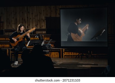 Dnepr, Ukraine- April 15, 2021: Man Play Acoustic An Electric Acoustic Ten-string Midi Guitar With Online Livestream Performance On Screen