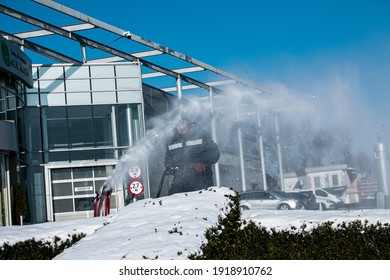 Dnepropetrovsk, Ukraine - 02.16.2021: City Municipal Service Cleans City Streets After Heavy Snowfall. A Man Cleans Deep Snow With A Caterpillar Snow Blower.