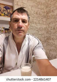 Dnipro City And Dnipropetrovsk Region, Ukraine August 2022 A Man At Home Holds A Photo Session Drinks Milk From A Glass