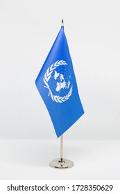 Dnipro, Ukraine - April 11, 2020: Desktop Flag Of The UN On Metal Flagpole Isolated On White Background. National Symbol