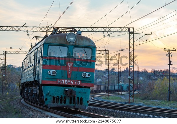 Dnipro, Ukraine - autumn 2018: Electric\
locomotive VL11 pulls a train of freight cars with military\
equipment. Ukrainian\
railways.