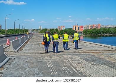 Dnipro, Ukraine - May 07, 2017: A Team Of Bridge Builders Goes To The Change Houses After A Work Shift