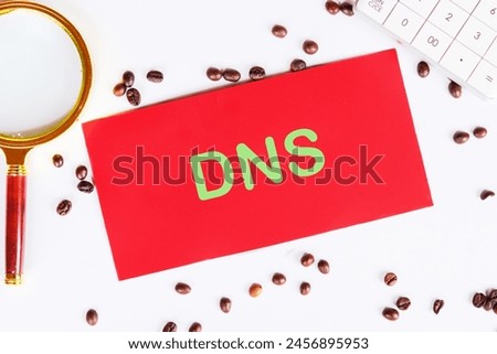 DNS Domain Name System Server Decentralized naming system for computers, devices, services, other resources on red paper on a white background with coffee beans and a magnifying glass