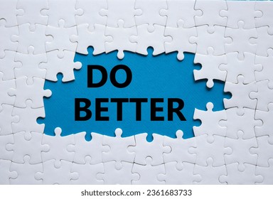 Do better symbol. White puzzle with words Do better. Beautiful blue background. Business and Do better concept. Copy space.