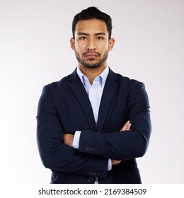 I Do Business With A No Nonsense Attitude. Studio Portrait Of A Confident Young Businessman Standing With His Arms Crossed Against A White Background.