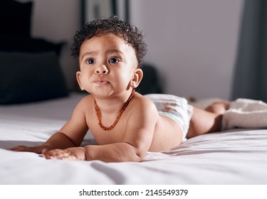 Do I Hear Mom Making A Bottle. Shot Of An Adorable Baby Boy On The Bed At Home.