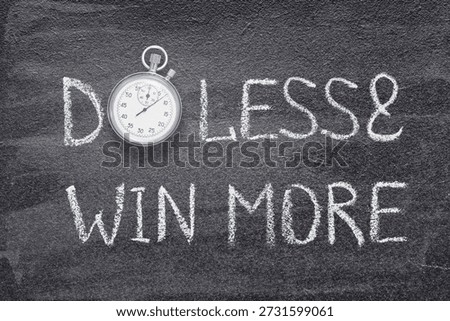 do less and win more phrase written on chalkboard with vintage precise stopwatch 