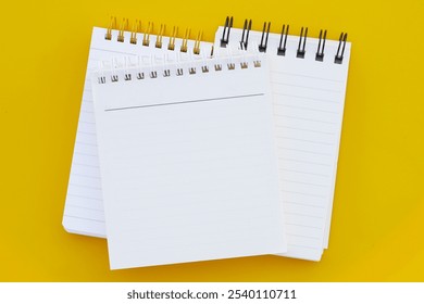 To do list note book on yellow background.