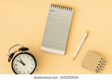 To do list in spiral notepad, retro alarm clock and white pen. Trendy pastel background, flat lay style. Planning concept. - Powered by Shutterstock